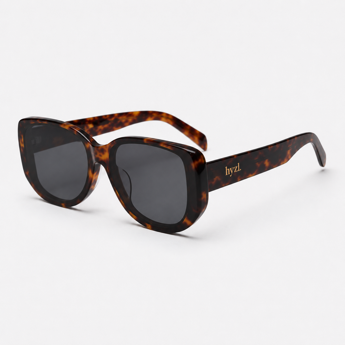 A pair of hyzl sunglasses with a dark brown and black tortoiseshell acetate frame and dark gray lenses, shown on a clean white background.