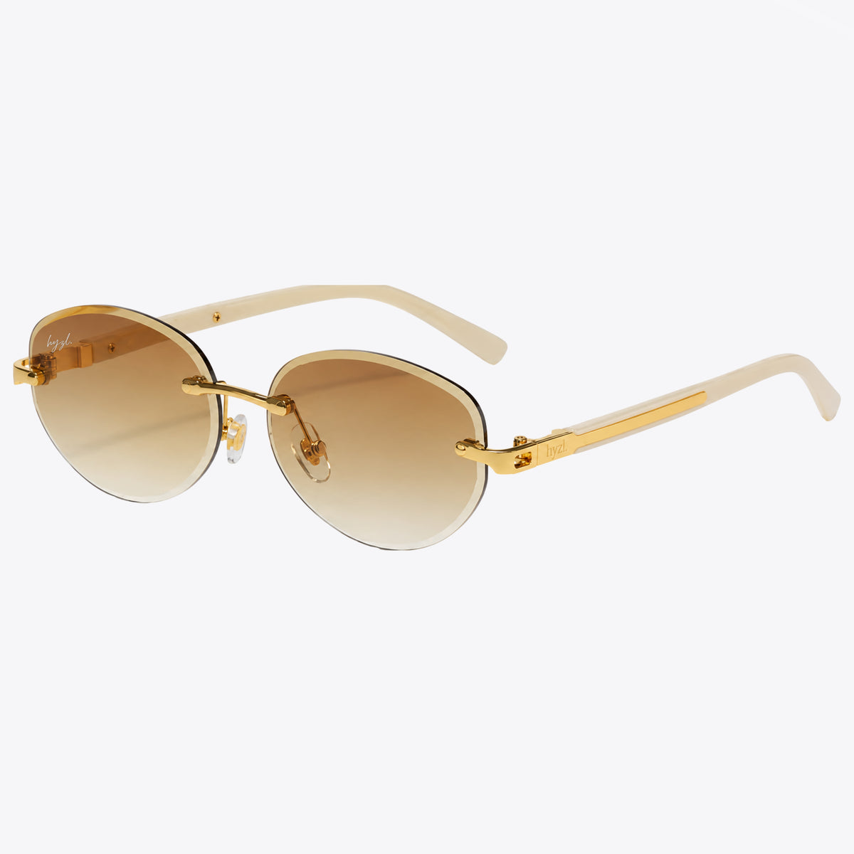 Gold-framed sunglasses with gradient brown lenses on a white background