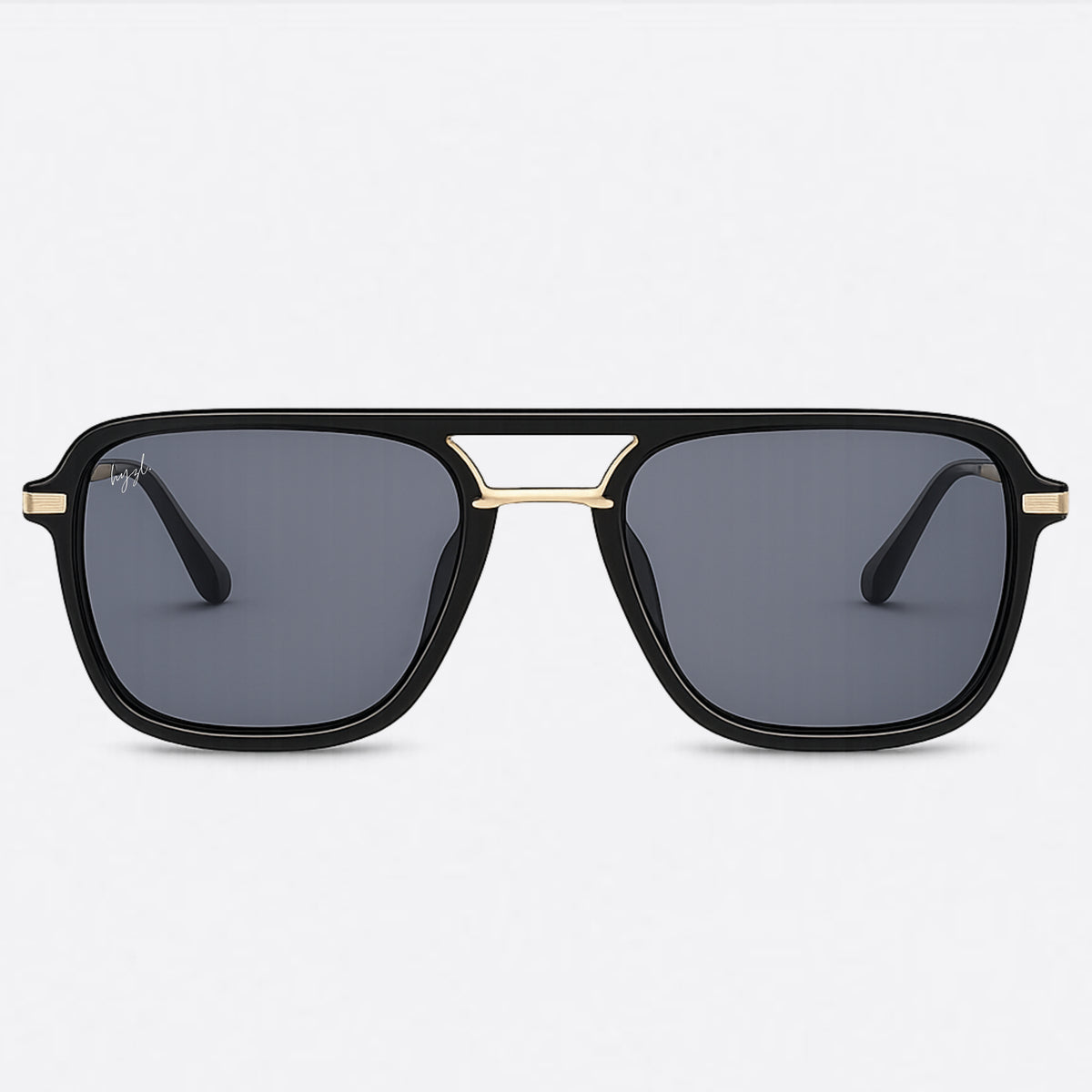 A pair of square aviator-style sunglasses with a glossy black frame, gold metal accents at the top bridge and temples, and dark gray lenses, shown against a light gray background.