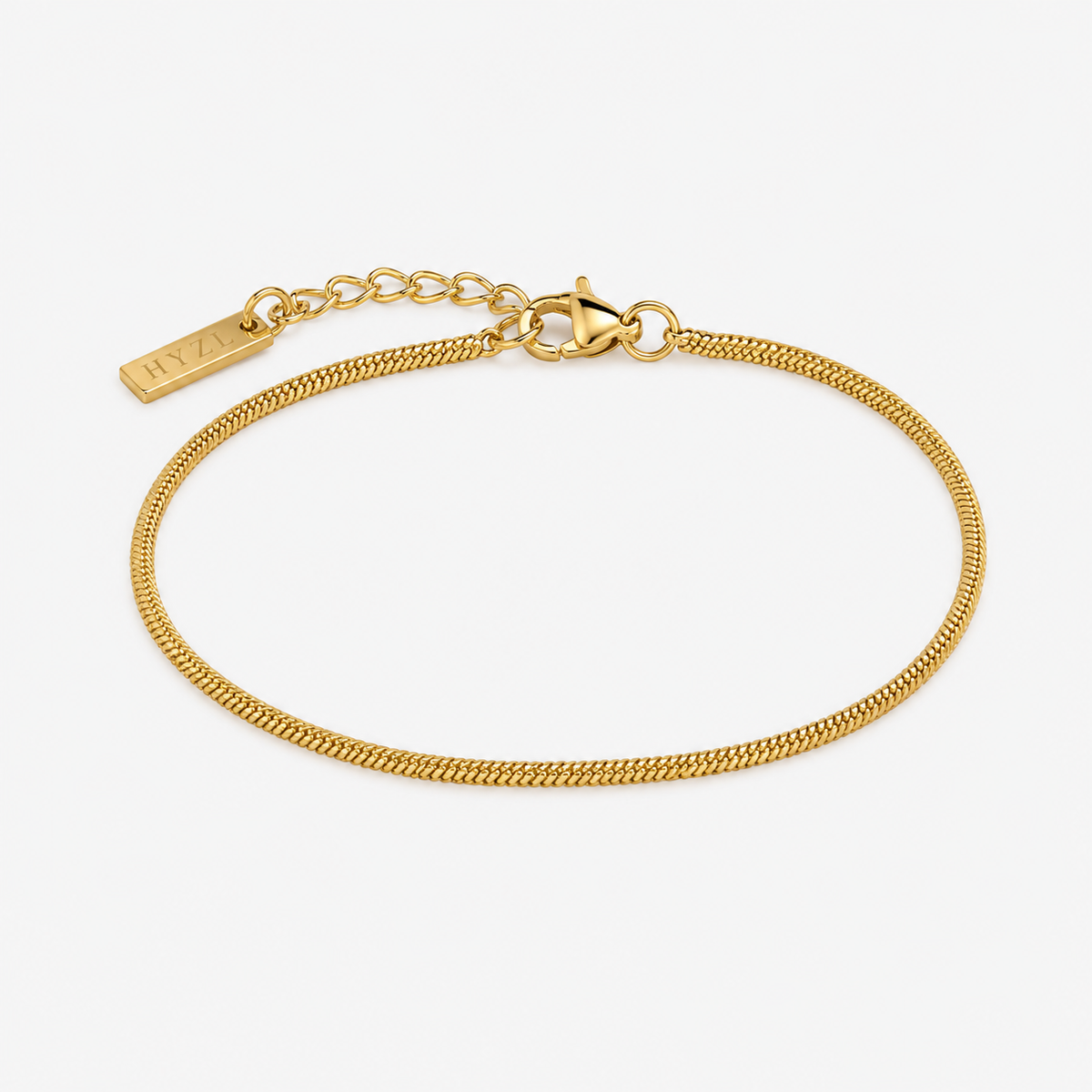A gold chain bracelet with a lobster clasp and an adjustable extender chain featuring a small rectangular tag engraved with 'MIA', displayed on a clean white background.