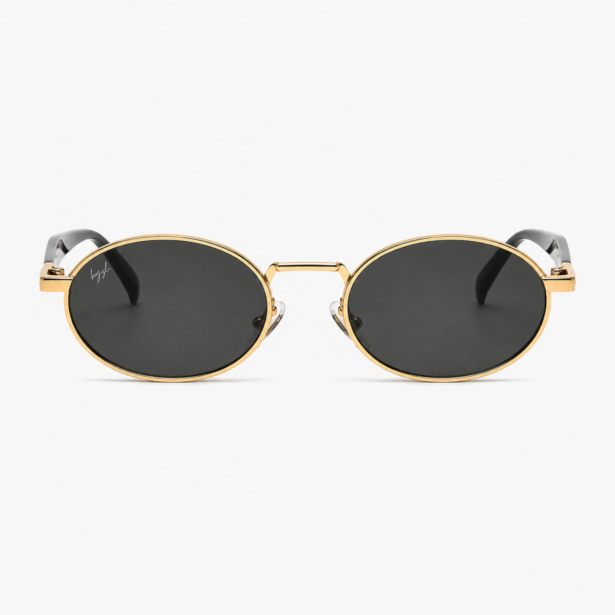 Oval sunglasses with a gold metal frame, dark lenses, and black temple tips, shown against a light gray background.