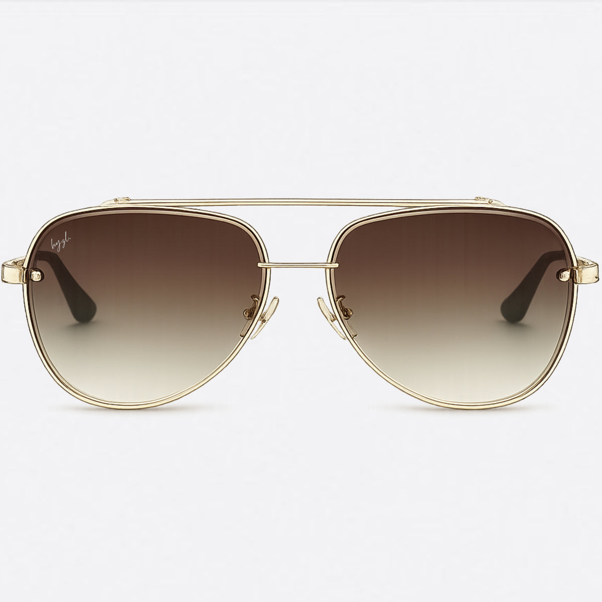 Aviator sunglasses with a gold-tone metal frame and brown gradient lenses, shown against a light gray background.
