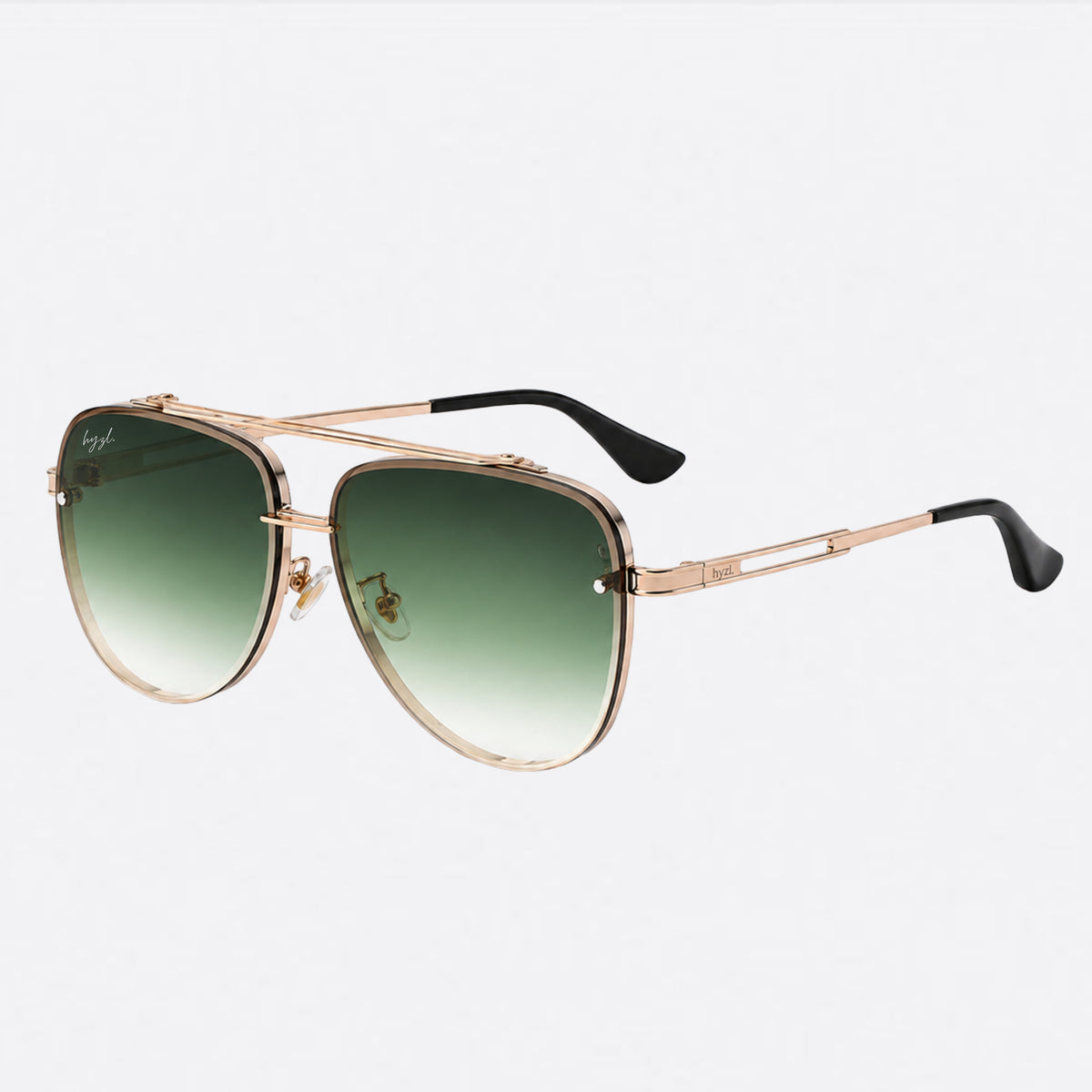 Sunglasses with gold frame and brown gradient lenses on a white background