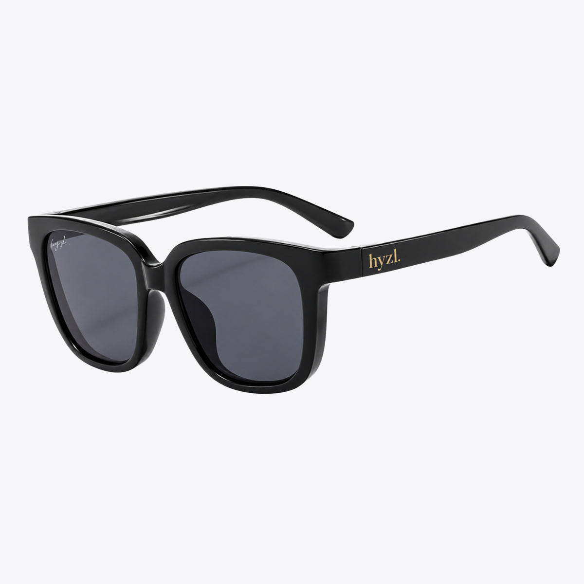 Black square sunglasses with dark gray lenses and gold hyzl branding on the temple, shown on a light gray background.